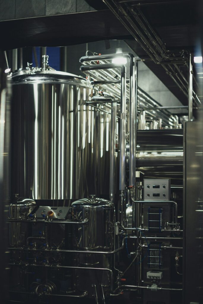 Modern brewery equipment with pipes and fermenting tank