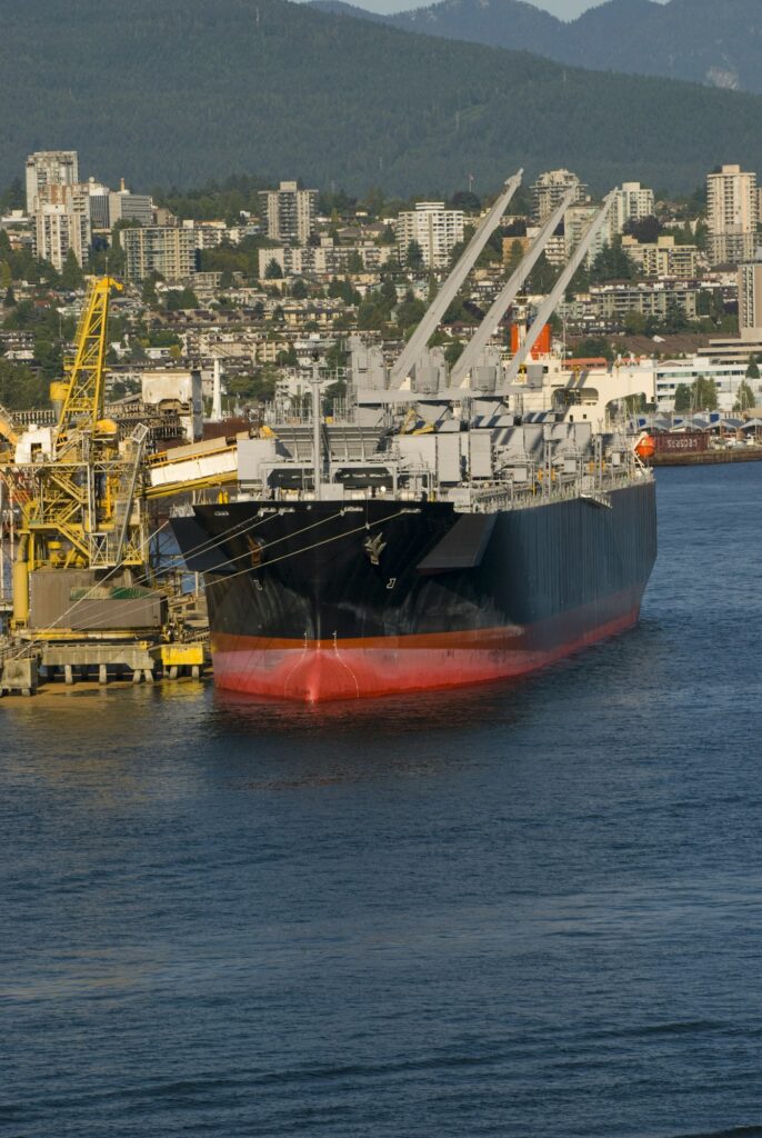 Vertical shot of a cargo ship in harbor